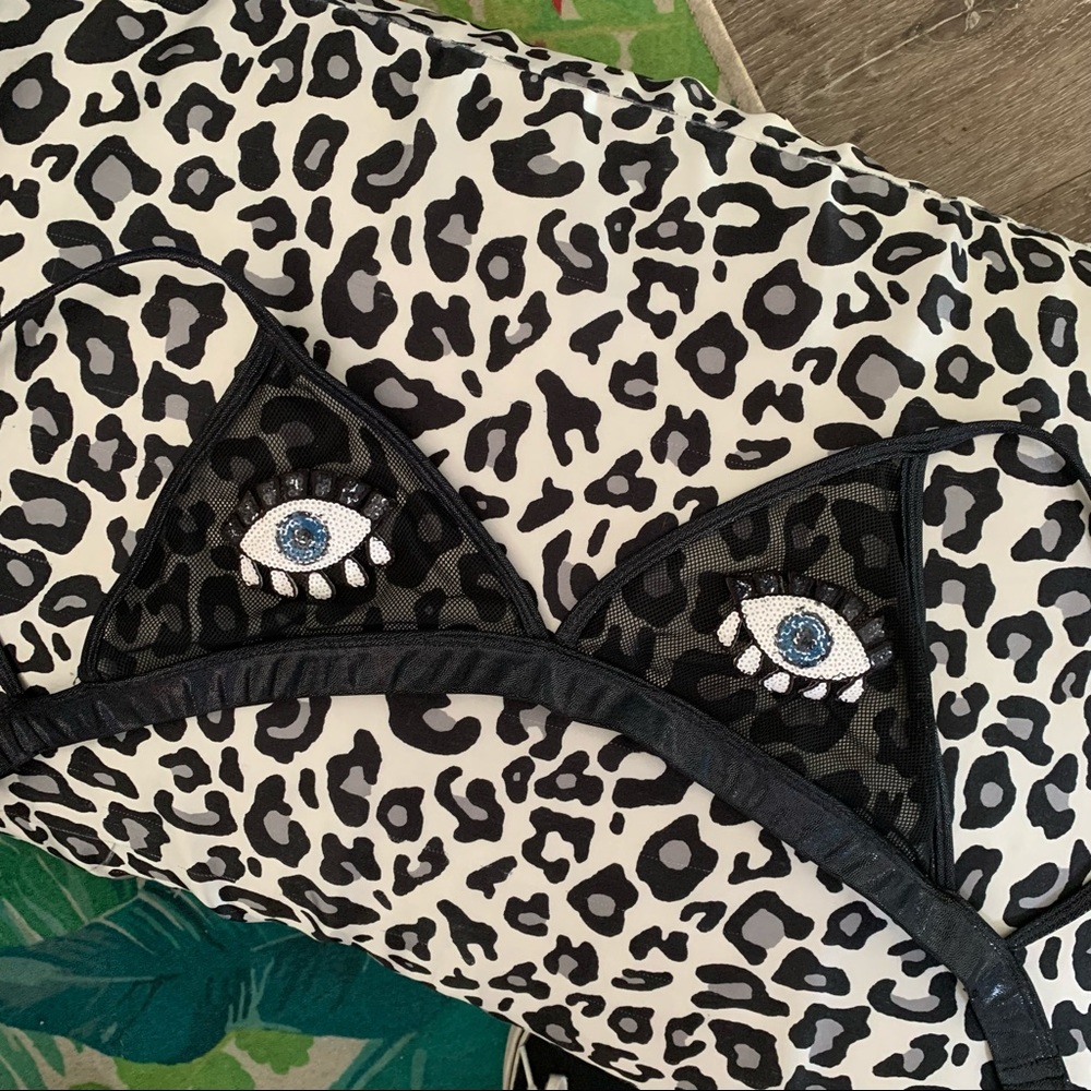 Custom black mesh bra top with eye appliqués.